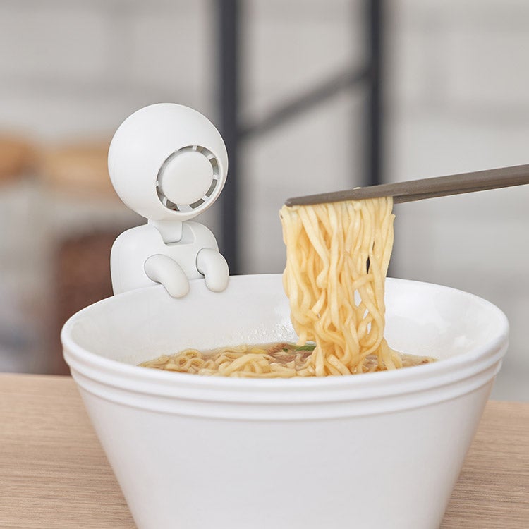 YU-REI fan hanging from the rim of a cup