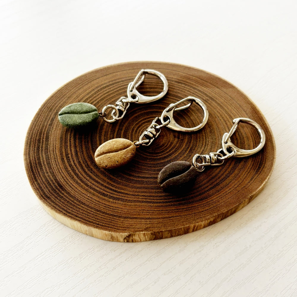 COFFEE STONE coffee bean key ring attached to a bag